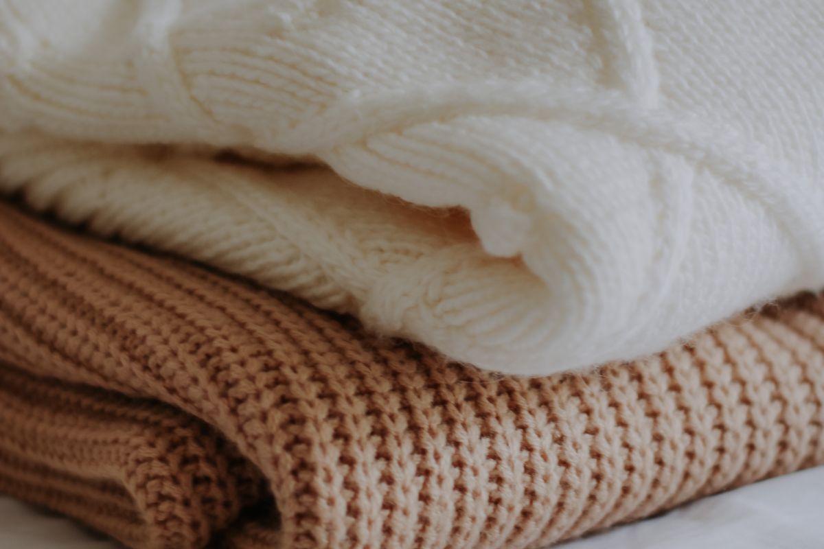 Folded wool knitwear sweaters stacked in a neat pile